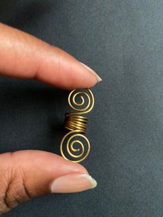 Traditional loc jewelry finished with an untraditional spiral! Spiral Single Brass Earring, Single Spiral Brass Earring, Spiral Brass Single Earring, Brass Spiral Single Earring, Spiral Brass Wire Wrapped Jewelry, Spiral Brass Jewelry, Spiral Wire Wrapped Brass Jewelry, Bohemian Gold Spiral Wrap Earrings, Unique Spiral Hand Wrapped Jewelry