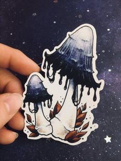 a hand holding a sticker with an image of a jellyfish