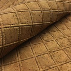 a close up view of a tan colored couch cushion