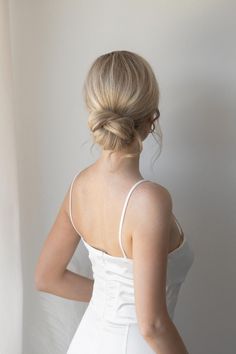 a woman in a white dress is posing for the camera