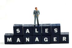 a miniature man standing on top of blocks that spell sales manager royalty photos and images