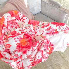 a red and white floral print scarf on a couch