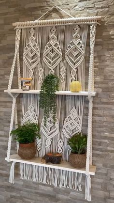 macrame wall hanging shelf with plants on it