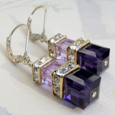 Modern and gorgeous deep purple and light violet dangle earrings are handmade with two contrasting hues of Swarovski crystal cubes in the purple violet family of colors. Accented with Swarovski crystal rhinestone crowns and crystals. Shown on 14k gold filled leverback earring closures for a secure fasten. Available in sterling silver. Gorgeous earrings for parties, elegant events and weddings. Available in multiples for bridesmaids gifts. Earring Details: - Earring length is 1.50 inches (3.81 cm Jewerly Organizer, Black Pearl Earrings, Etsy Ideas, Purple Earrings, Cool Ideas, Swarovski Crystal Earrings, Swarovski Earrings, Purple Fashion, Bridesmaid Earrings