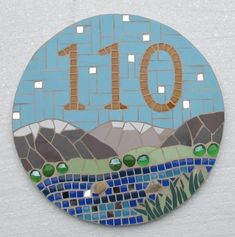 a mosaic tile sign with the number ten on it