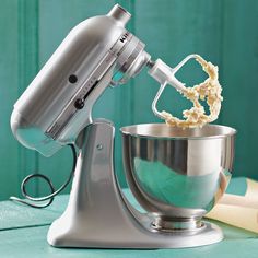 an electric mixer is being used to make macaroni and cheese