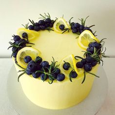 a yellow cake with blueberries and lemon slices