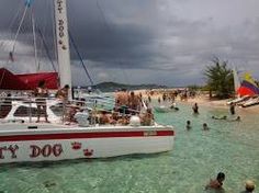 people are swimming in the water near a boat