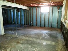 an unfinished room with exposed walls and concrete flooring