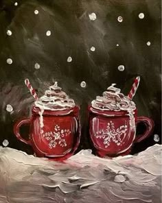 two red mugs with candy canes in them