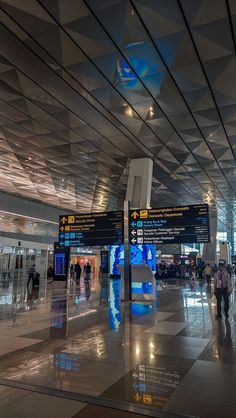 people are walking through an airport terminal