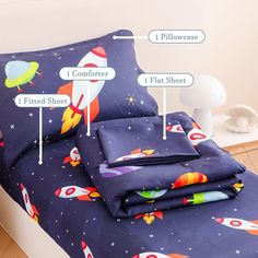 an image of a bed with space themed sheets and pillowcases on the bottom