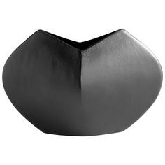 a black vase sitting on top of a white table