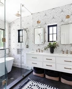 a white bathroom with black and gold accents