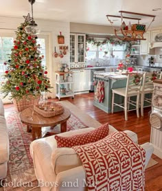 a living room filled with furniture and a christmas tree in the middle of the room