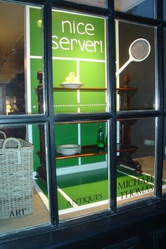 there is a store window that has tennis rackets in it