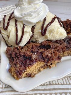 two desserts on a white plate with ice cream