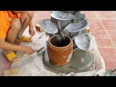 a man is working on cement with a knife and some other items in front of him