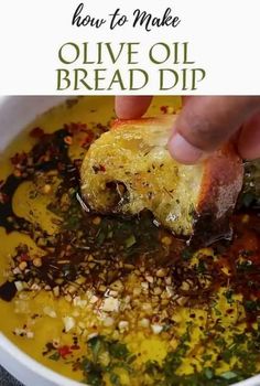 a hand dipping bread into a bowl of olive oil and herbs with the title above it