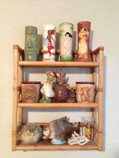 a shelf filled with vases and figurines on top of it