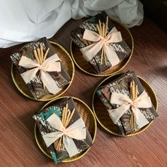 three brown plates with bows on them are sitting on the floor next to a bed