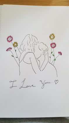 a drawing of two people hugging each other with flowers in front of them and the words i love you written on it