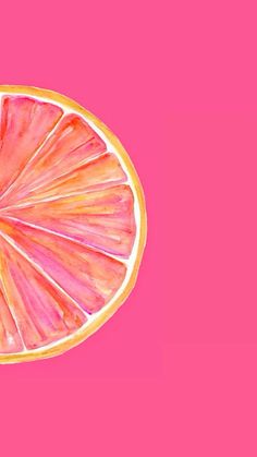 a grapefruit cut in half on a pink background with gold trimmings