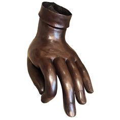 a bronze hand statue with a black rubber wrist