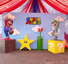 some paper mario decorations are on display in front of a red and white curtained wall