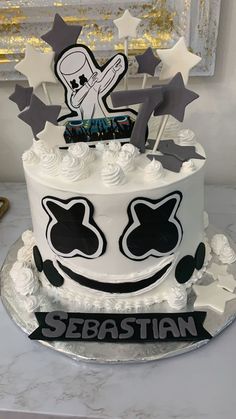 a white cake with black and silver decorations