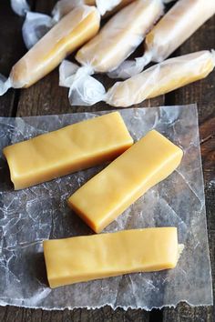 four pieces of cheese sitting on top of wax paper