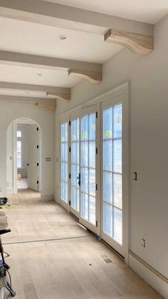 an empty room with white walls and wood flooring is being painted in the process of remodeling