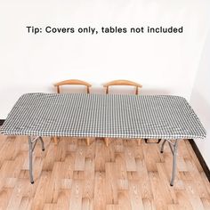 a table with two chairs and a checkered cloth on it, in front of a white wall that says tip covers only tables not included