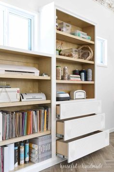 an open bookcase with many books and crafting supplies on the shelves next to it