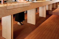 a woman sitting at a counter in a kitchen