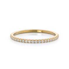 a yellow gold wedding band with white diamonds