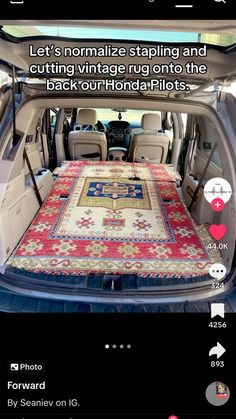 the trunk area of a car with carpet and rugs on it's floor