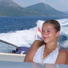 a woman sitting in the back of a boat