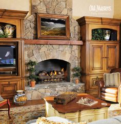 a living room filled with furniture and a fire place in the middle of a fireplace