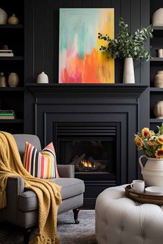 a living room filled with furniture and a fire place next to a painting on the wall