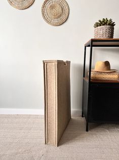 a book sitting on top of a table next to a hat rack and wall hangings