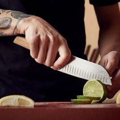 a man cutting limes with a large knife