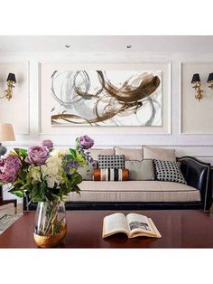 a living room filled with furniture and flowers on top of a wooden table in front of a painting