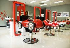 a salon with red and white chairs and mirrors on the wall, all in different colors