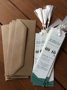 the wedding stationery is laid out on top of the wooden table, ready for guests to arrive