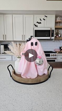 a kitchen counter with a pink towel on top of it