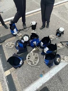 a group of people standing next to each other with musical instruments on the ground in front of them