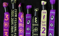 five purple and yellow lanyards with different designs on them, each featuring an eyeball