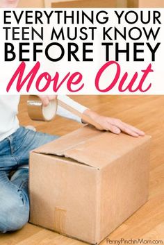 a person sitting on the floor with a cardboard box