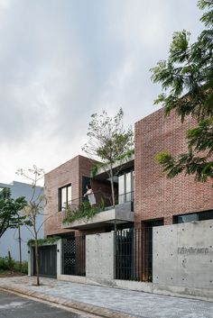 an apartment building with brick walls and balconies on the second floor is shown